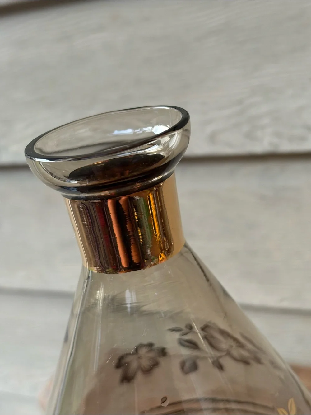 Art Deco decanter set features smoky purple glass adorned with a gold floral